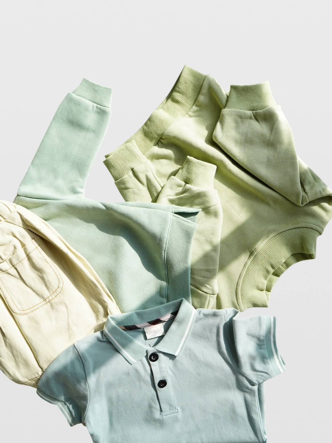 Club Enzo light blue button front polo collar short sleeve shirt on top of cream wide leg contrast stitch khaki pants and mint green long sleeve crew neck cotton sweatshirt with ribbed vent slit waist and relaxed fit for boys and girls toddler babies mom must haves infant plain cozy brush pullover sweatshirt made in Los Angeles kids and baby online clothing store boutique