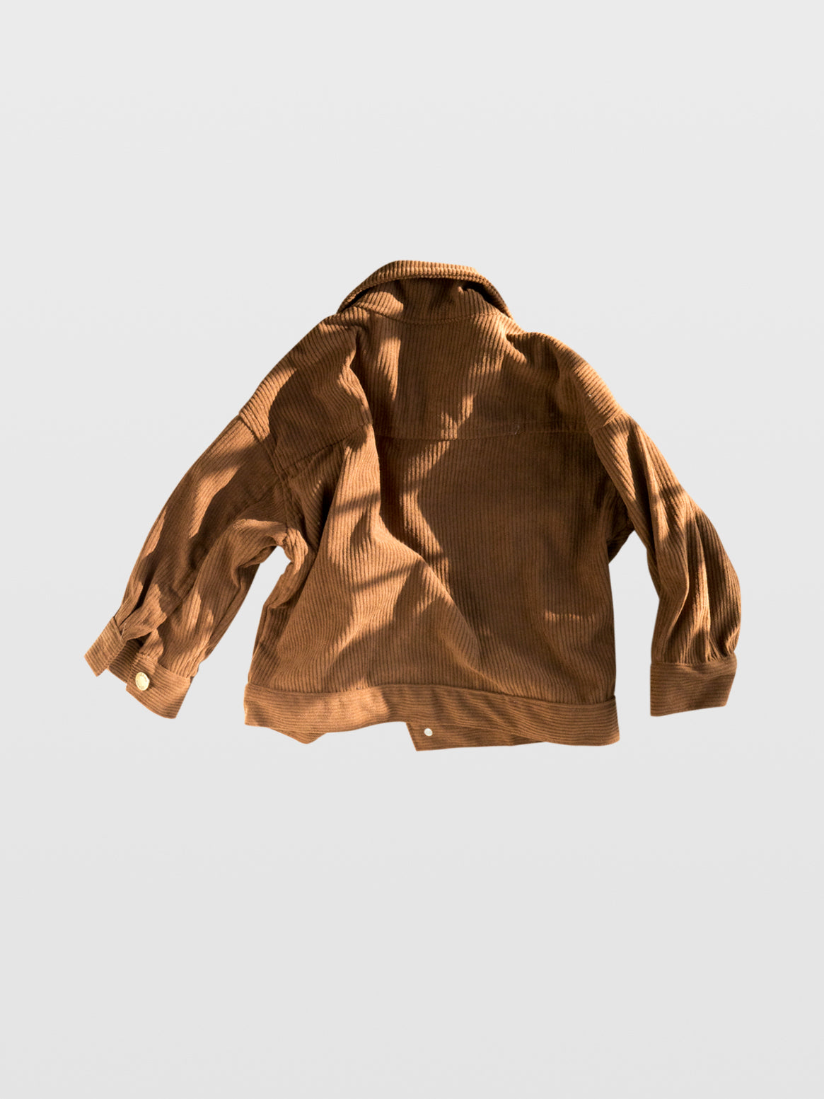 back of Brown corduroy long sleeve fall autumn winter jacket coat with gold metal snaps double front pockets and gold button wrist western clothes for toddlers baby boy clothes babies boys girls unisex cool kids mom must haves holiday gift guide trendy kids wear essentials made in Los Angeles toddler jacket kids shopping baby boy boutique baby boy clothes boutique kids shopping children’s boutique online shopping for kids kids wear near me baby clothes near me