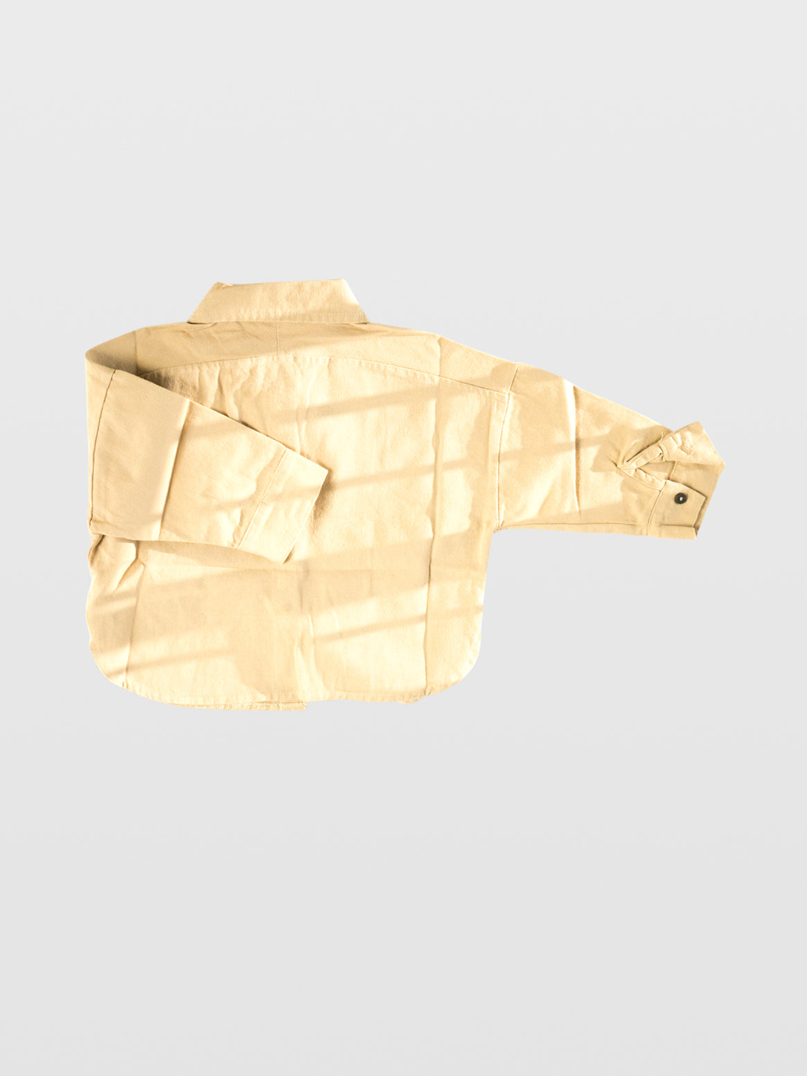 back image of Club Enzo cream canvas cotton long sleeve button up with collar and small front pocket and black buttons for trendy cool kids boys girls toddler babies mom must haves overshirt jacket wide relaxed fit for layering made in Los Angeles online kids clothing store boutique near me