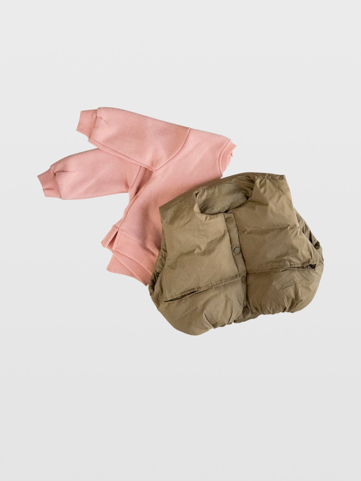Club Enzo tan puffer vest with button front and slit pockets on top of pink plush cotton sweatshirt with vent slit sides, crew neck, ribbed sleeve best toddler shirt for toddler boys and girls so cozy kids lined no sleeve pullover snap front plain tan cool moms must have best kids designer clothes online boutique