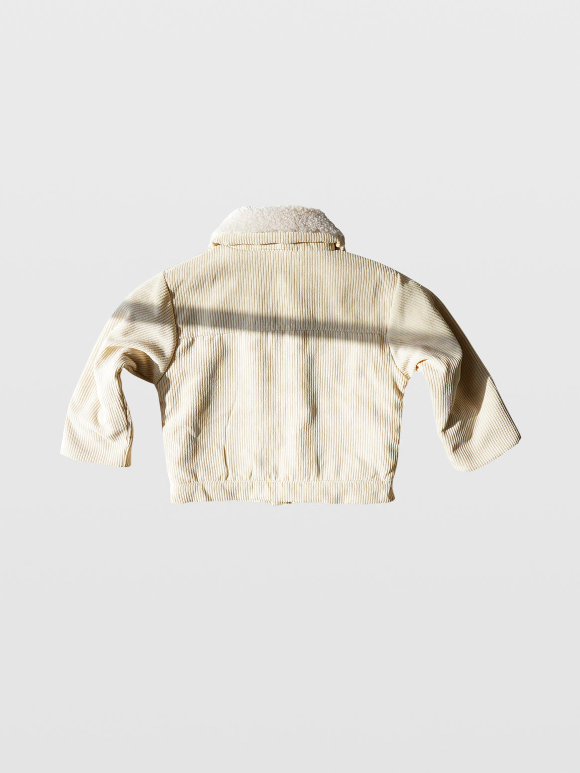 back of Cream corduroy long sleeve fall autumn winter jacket coat with metal buttons double front pockets and off white sherpa collar and lining western clothes for toddlers baby boy clothes babies boys girls unisex cool kids mom must haves holiday gift guide trendy kids wear essentials made in Los Angeles toddler jacket kids shopping baby boy boutique baby boy clothes boutique kids shopping children’s boutique online shopping for kids kids wear near me baby clothes near me